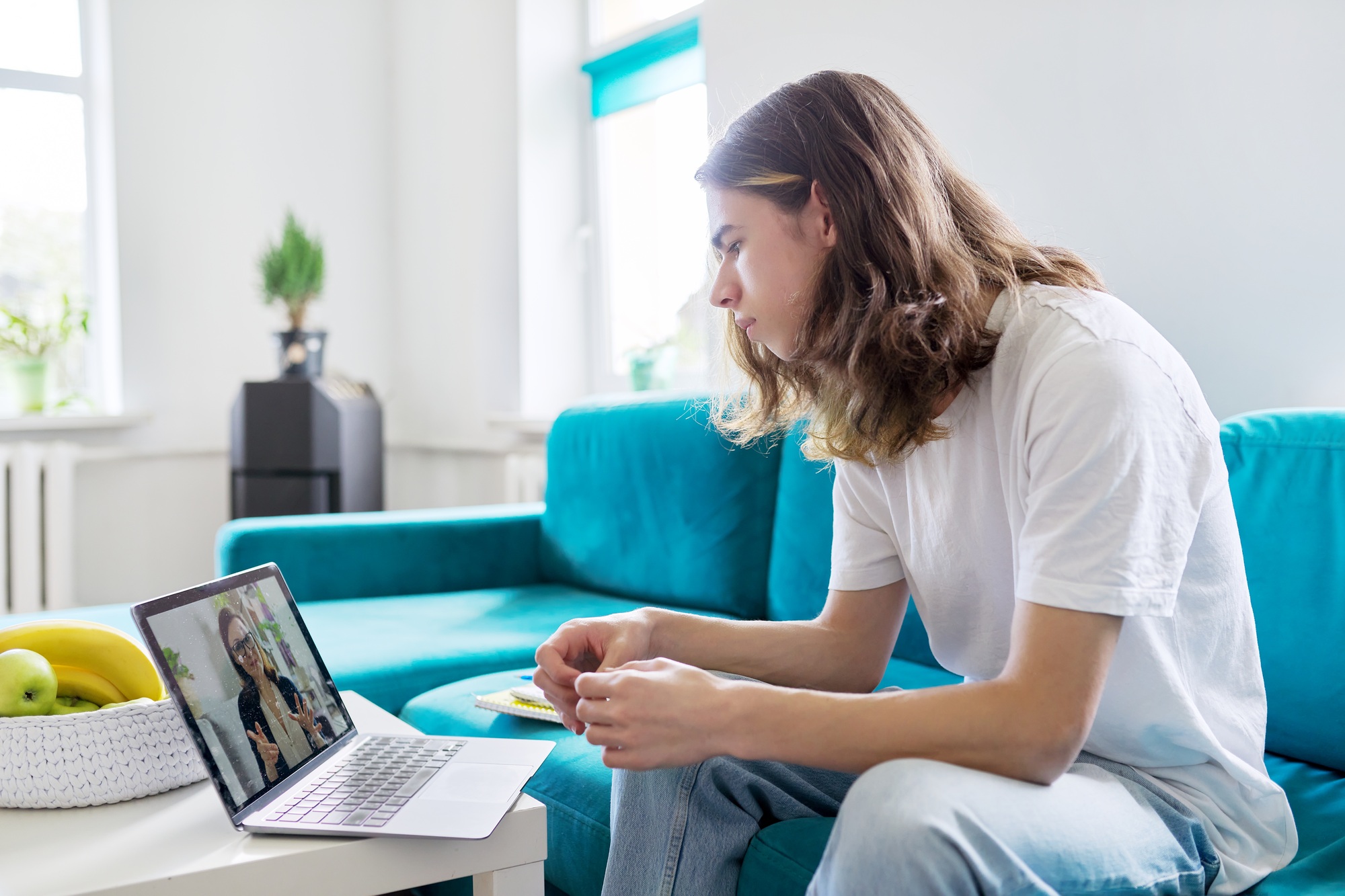 Individual online lesson, teenage boy studying at home with laptop
